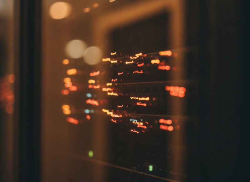 Infrastructure lights reflected in a single dark pane